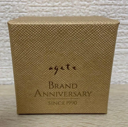 Agete 33rd anniversary charm accessory with intricate design, shown on a white background