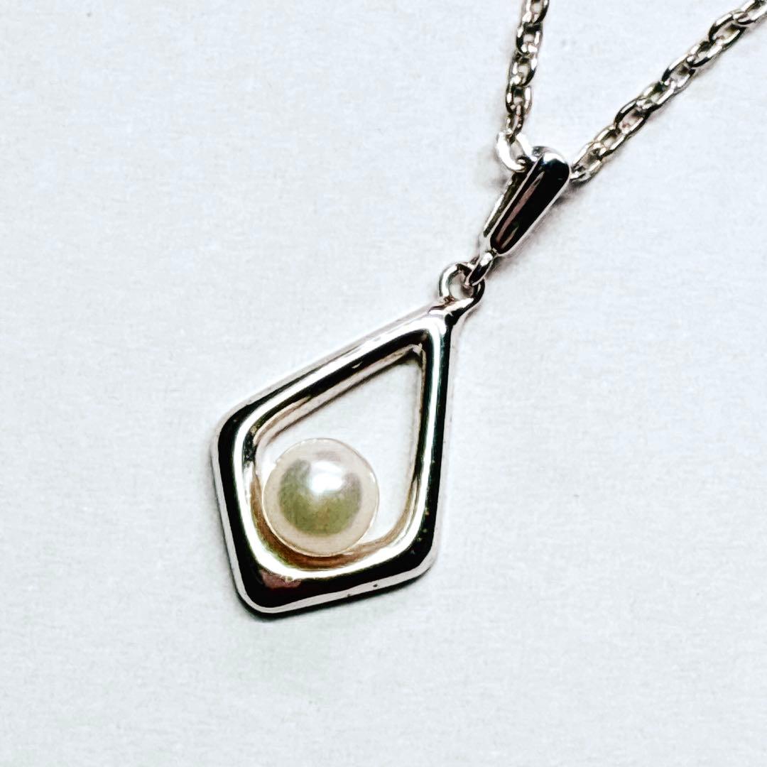 Mikimoto Akoya baby pearl necklace with 38 cm silver chain and engraved clasp shown on white background