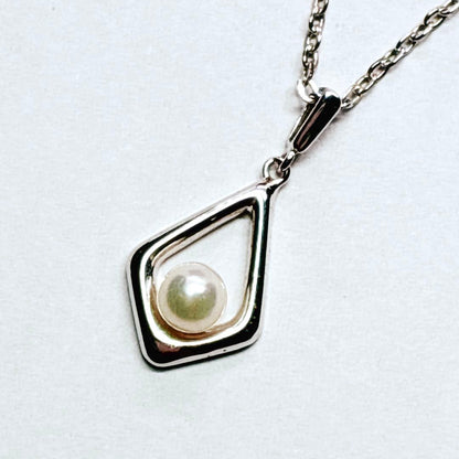 Mikimoto Akoya baby pearl necklace with 38 cm silver chain and engraved clasp shown on white background