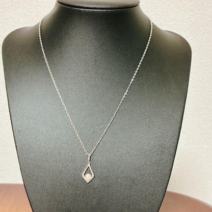 Mikimoto Akoya baby pearl necklace with 38 cm silver chain and engraved clasp shown on white background