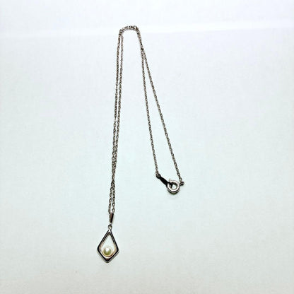 Mikimoto Akoya baby pearl necklace with 38 cm silver chain and engraved clasp shown on white background