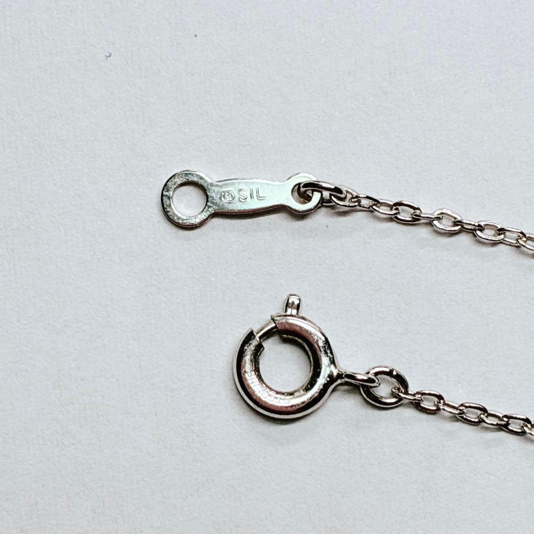 Mikimoto Akoya baby pearl necklace with 38 cm silver chain and engraved clasp shown on white background