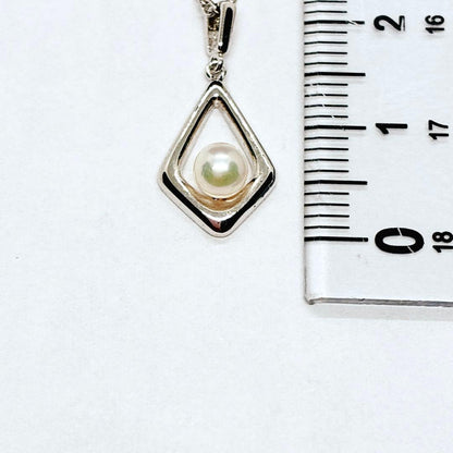 Mikimoto Akoya baby pearl necklace with 38 cm silver chain and engraved clasp shown on white background