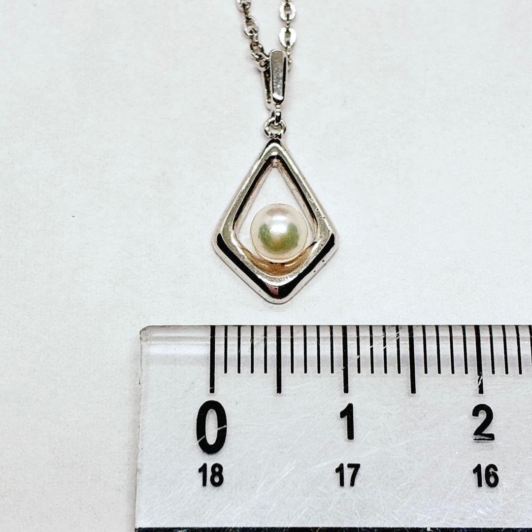 Mikimoto Akoya baby pearl necklace with 38 cm silver chain and engraved clasp shown on white background