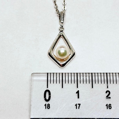 Mikimoto Akoya baby pearl necklace with 38 cm silver chain and engraved clasp shown on white background