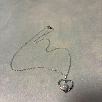 Mikimoto silver necklace featuring a 6.5mm pearl set in a heart-shaped motif pendant on a 40cm chain