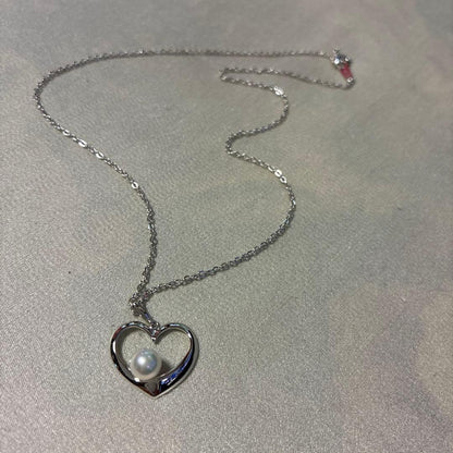 Mikimoto silver necklace featuring a 6.5mm pearl set in a heart-shaped motif pendant on a 40cm chain