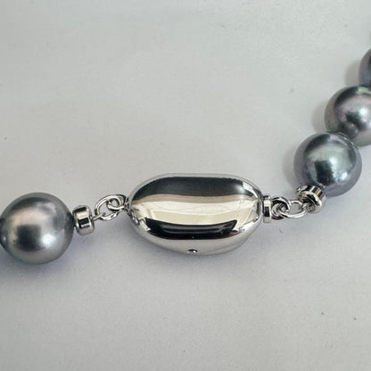Akoya pearl necklace 42cm with natural white pearls and a silver clasp on white background