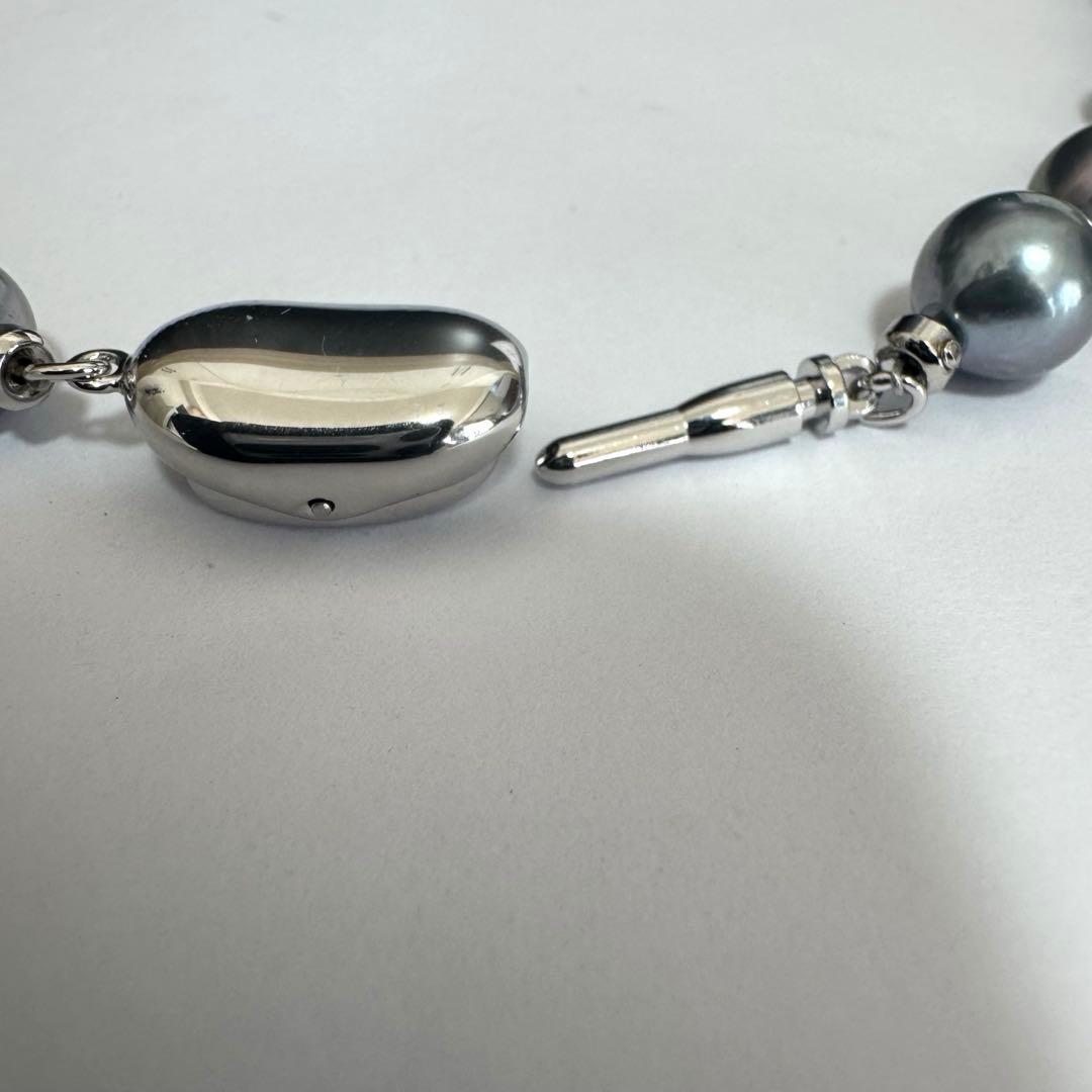 Akoya pearl necklace 42cm with natural white pearls and a silver clasp on white background