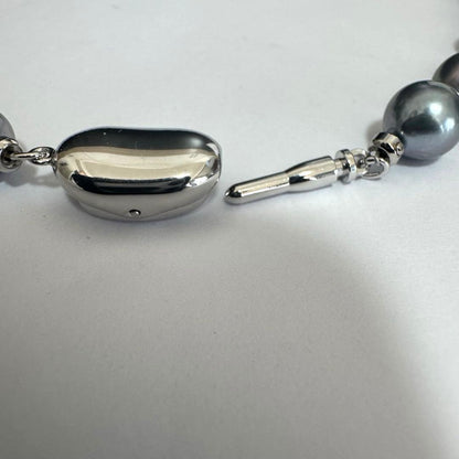 Akoya pearl necklace 42cm with natural white pearls and a silver clasp on white background