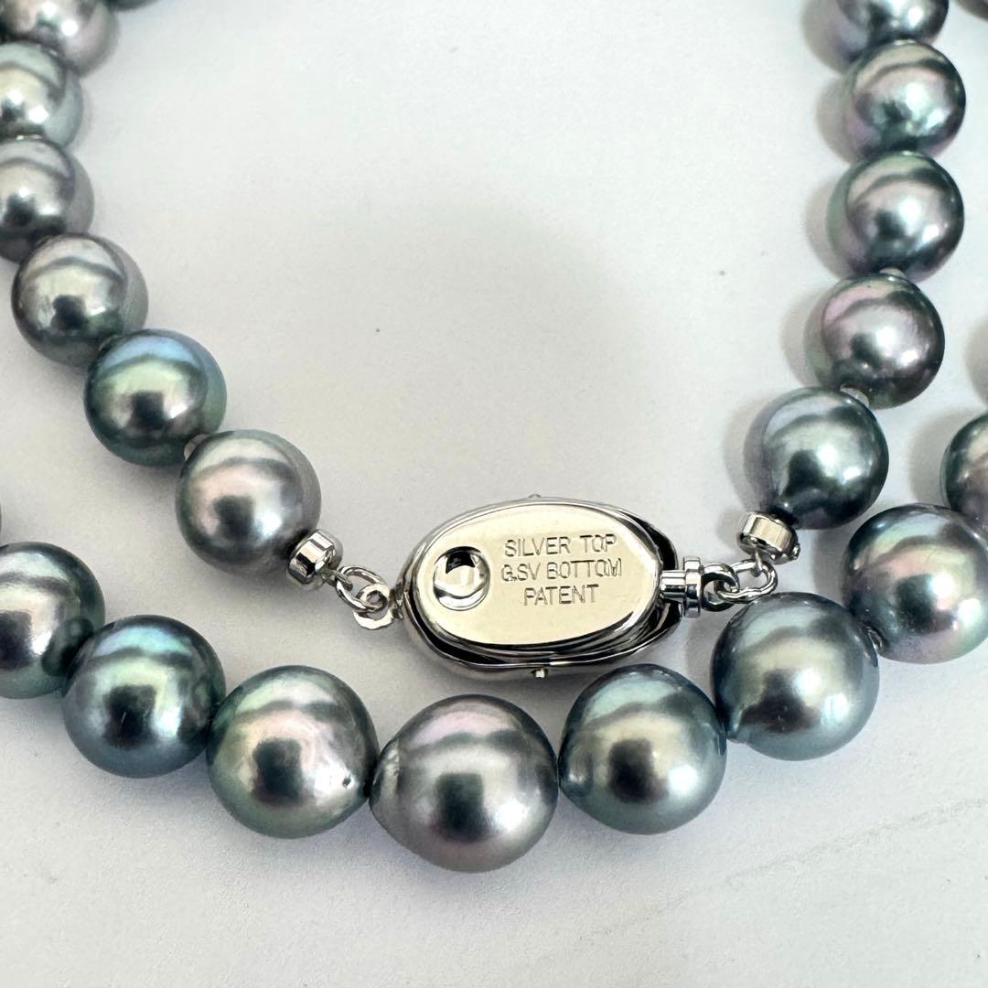Akoya pearl necklace 42cm with natural white pearls and a silver clasp on white background
