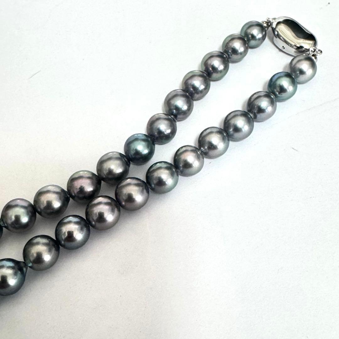 Akoya pearl necklace 42cm with natural white pearls and a silver clasp on white background