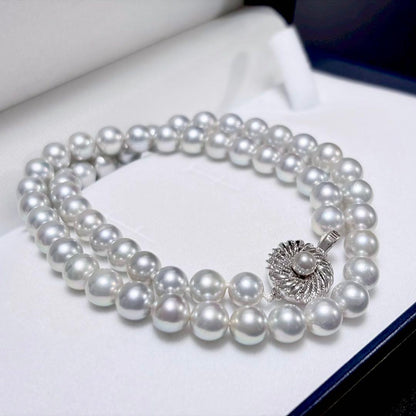 Akoya pearl necklace with 6.9-7.5mm light gray pearls and silver clasp on a white background