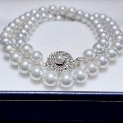 Akoya pearl necklace with 6.9-7.5mm light gray pearls and silver clasp on a white background