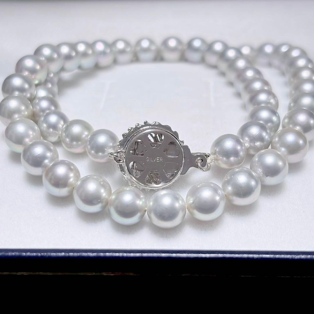 Akoya pearl necklace with 6.9-7.5mm light gray pearls and silver clasp on a white background