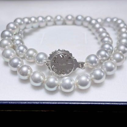 Akoya pearl necklace with 6.9-7.5mm light gray pearls and silver clasp on a white background