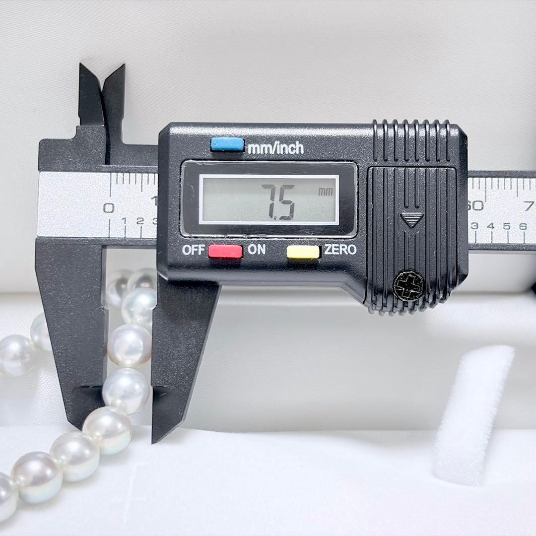 Akoya pearl necklace with 6.9-7.5mm light gray pearls and silver clasp on a white background