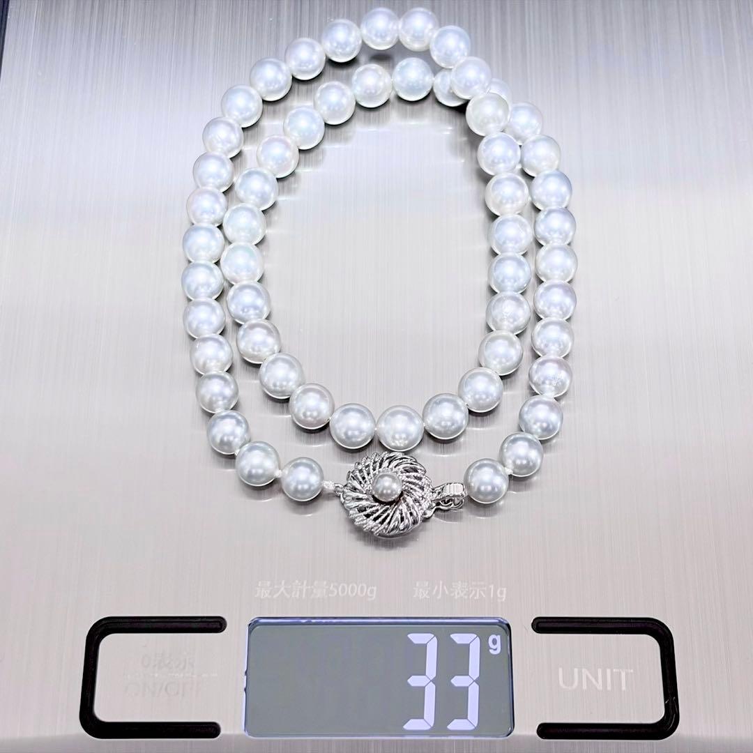 Akoya pearl necklace with 6.9-7.5mm light gray pearls and silver clasp on a white background