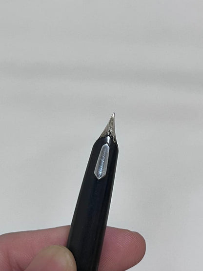 14K pen tip PILOT fountain pen with black and silver body and inset nib on white background