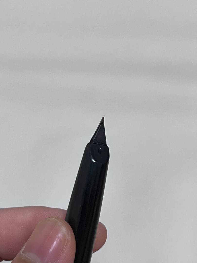 14K pen tip PILOT fountain pen with black and silver body and inset nib on white background