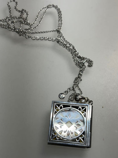 Mikimoto pearl necklace with decorative silver geometric pendant and removable rocket-shaped charm on adjustable chain