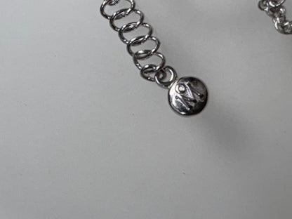 Mikimoto pearl necklace with decorative silver geometric pendant and removable rocket-shaped charm on adjustable chain