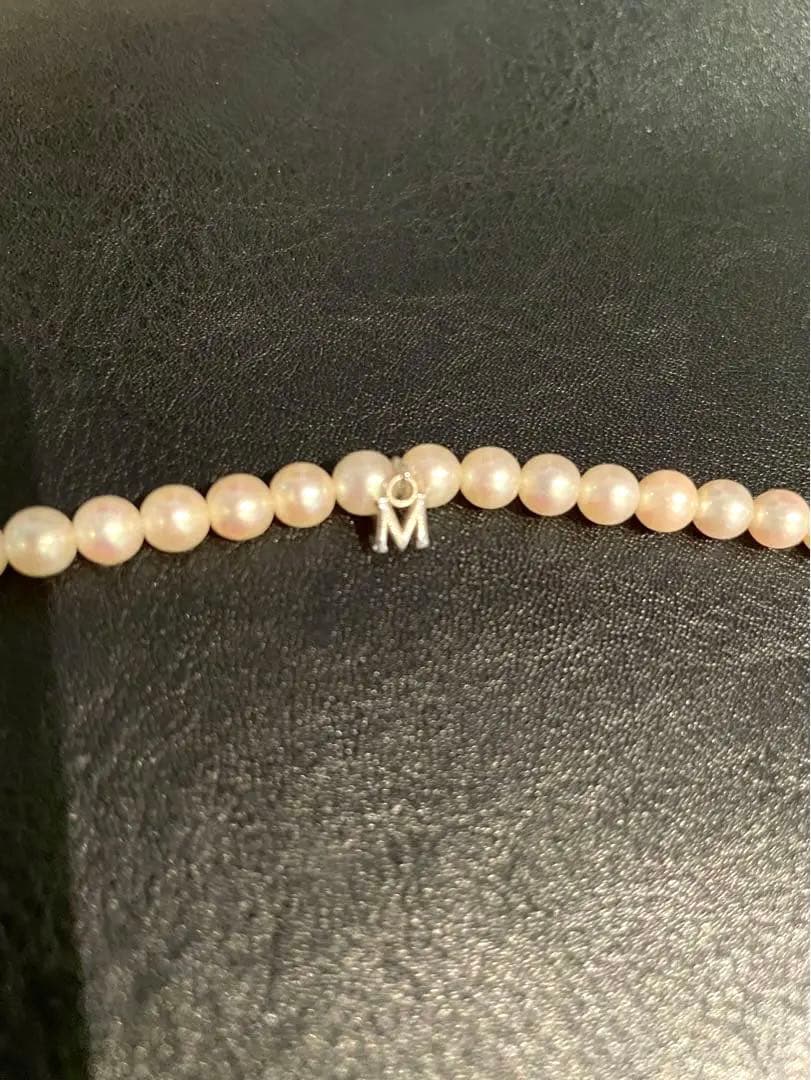 Mikimoto pearl necklace with silver M charm featuring 5 to 5.5 mm pearls and 43 cm silver clasp chain