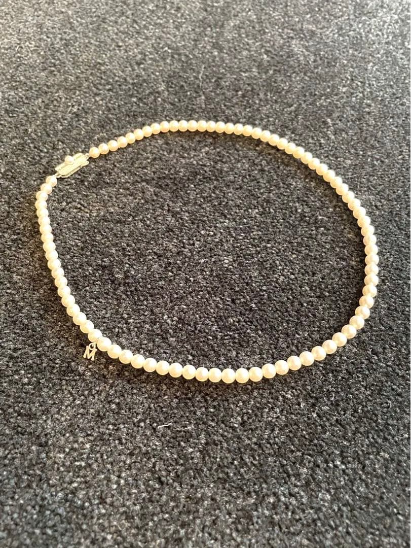 Mikimoto pearl necklace with silver M charm featuring 5 to 5.5 mm pearls and 43 cm silver clasp chain