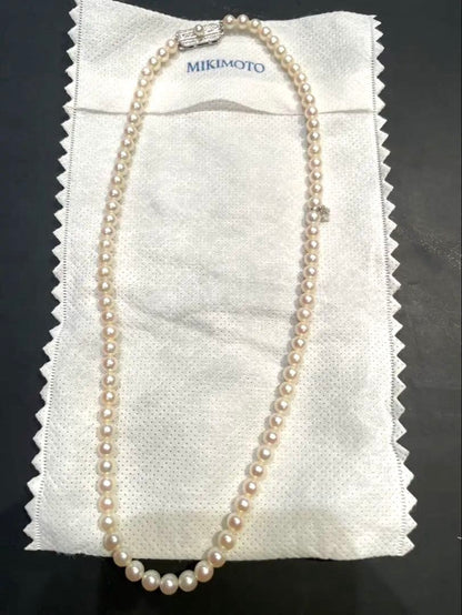 Mikimoto pearl necklace with silver M charm featuring 5 to 5.5 mm pearls and 43 cm silver clasp chain