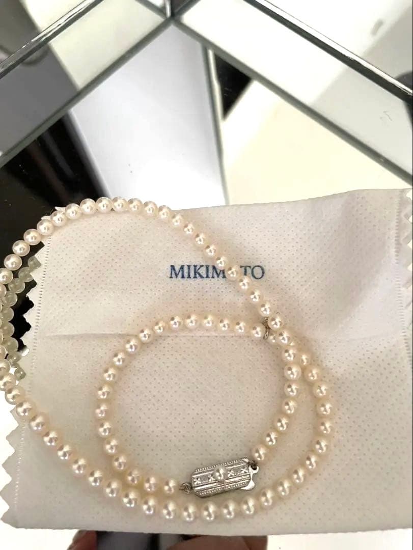 Mikimoto pearl necklace with silver M charm featuring 5 to 5.5 mm pearls and 43 cm silver clasp chain