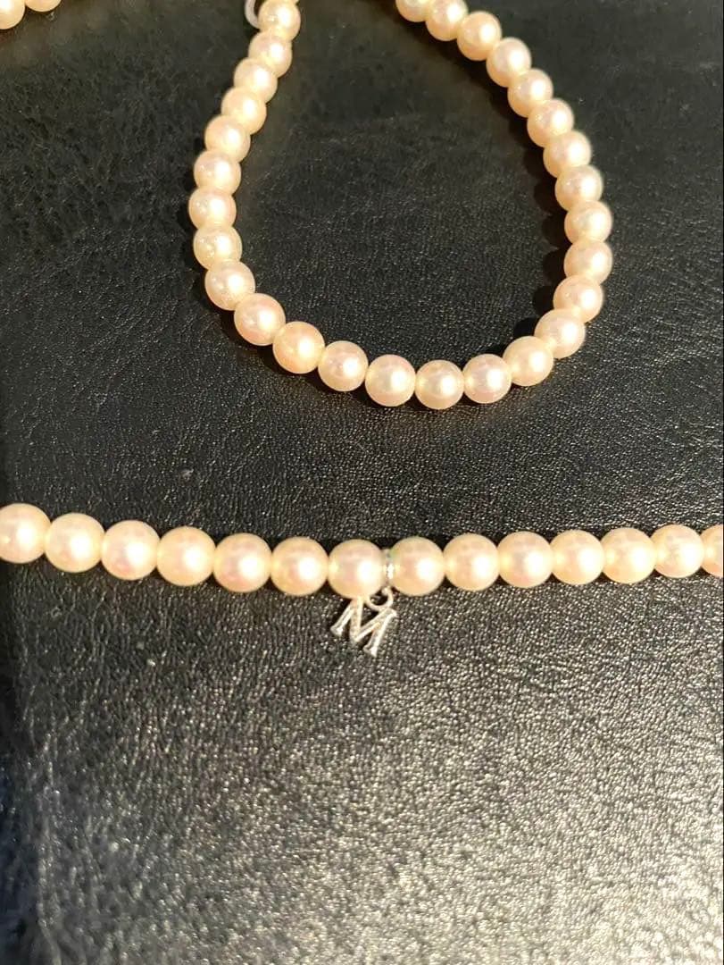 Mikimoto pearl necklace with silver M charm featuring 5 to 5.5 mm pearls and 43 cm silver clasp chain