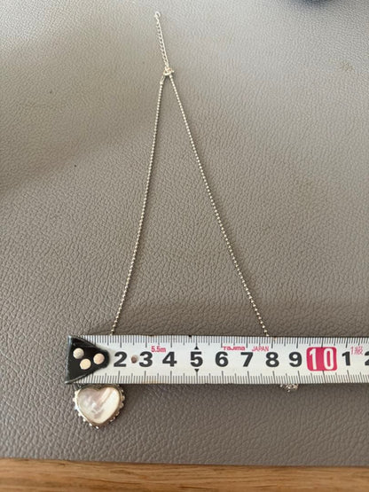 Agete white mother-of-pearl reversible heart-shaped necklace on a chain