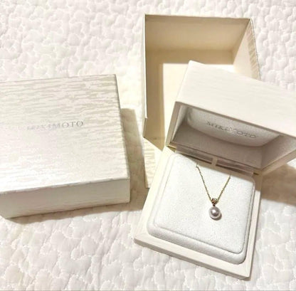 MIKIMOTO 18K gold necklace with pearl and diamond decorations displayed in a dedicated case