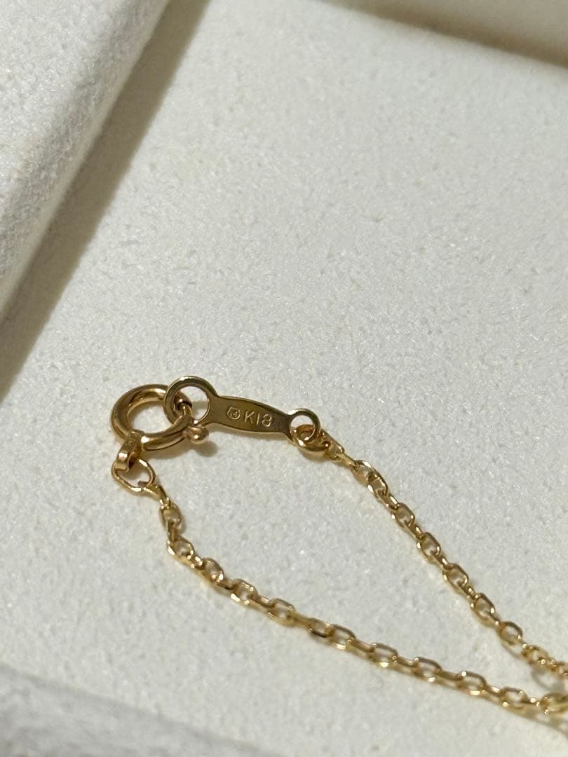 MIKIMOTO 18K gold necklace with pearl and diamond decorations displayed in a dedicated case