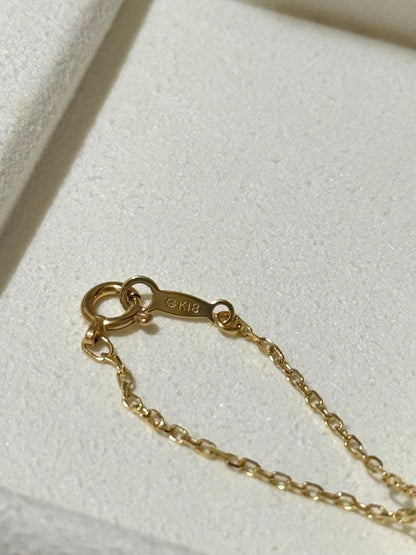 MIKIMOTO 18K gold necklace with pearl and diamond decorations displayed in a dedicated case