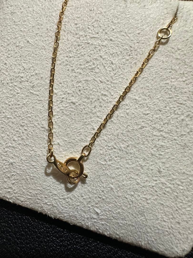 MIKIMOTO 18K gold necklace with pearl and diamond decorations displayed in a dedicated case