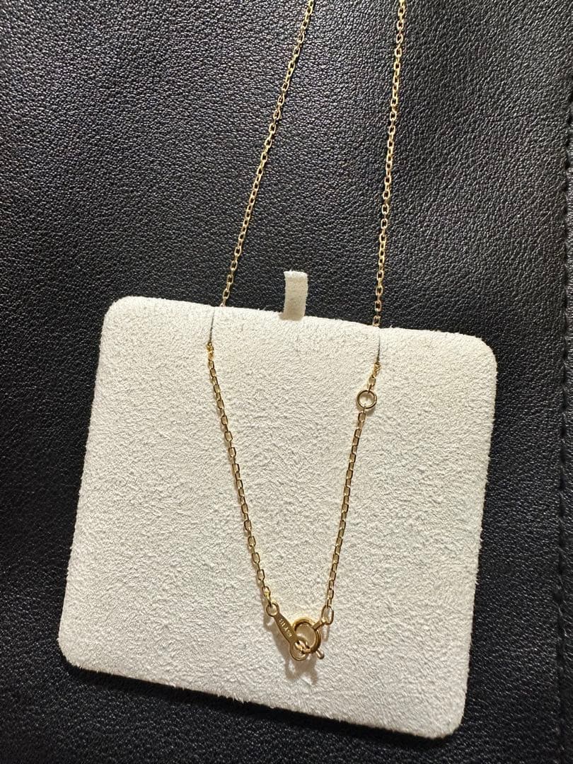 MIKIMOTO 18K gold necklace with pearl and diamond decorations displayed in a dedicated case