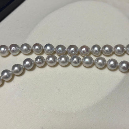 Akoya pearl necklace measuring 43.5 cm with round 8.0-8.5 mm white pearls on a white background