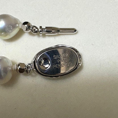 Akoya pearl necklace measuring 43.5 cm with round 8.0-8.5 mm white pearls on a white background
