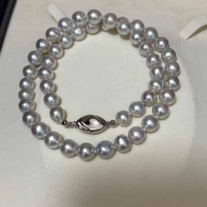 Akoya pearl necklace measuring 43.5 cm with round 8.0-8.5 mm white pearls on a white background