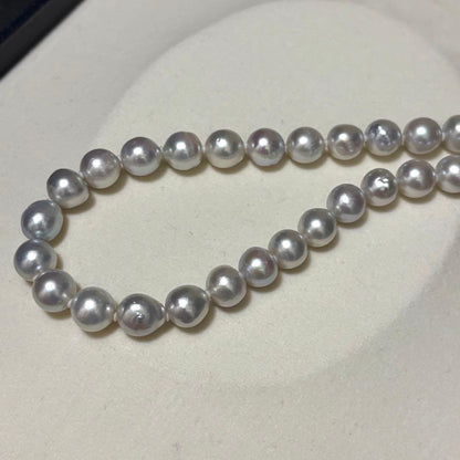 Akoya pearl necklace measuring 43.5 cm with round 8.0-8.5 mm white pearls on a white background