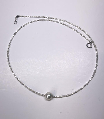 Akoya Keshi Necklace featuring small baroque pearls and a greenish pink Akoya pearl on a 42cm wire finish chain with metal clasp