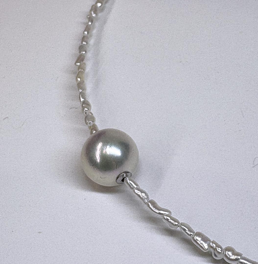 Akoya Keshi Necklace featuring small baroque pearls and a greenish pink Akoya pearl on a 42cm wire finish chain with metal clasp
