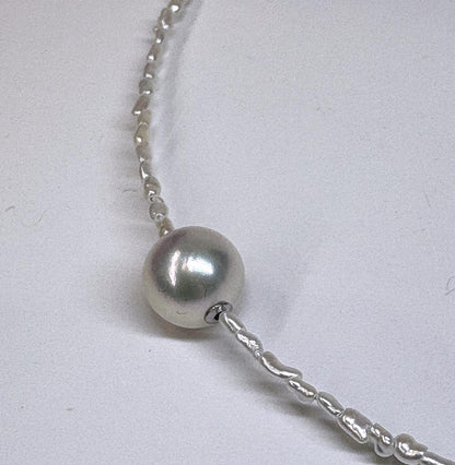 Akoya Keshi Necklace featuring small baroque pearls and a greenish pink Akoya pearl on a 42cm wire finish chain with metal clasp