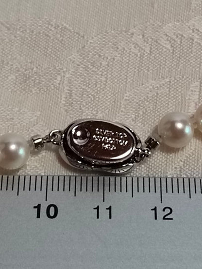 Akoya pearl necklace with 6.5-6.7mm white semi-round pearls and silver engraved bean-shaped clasp, 42.5cm length