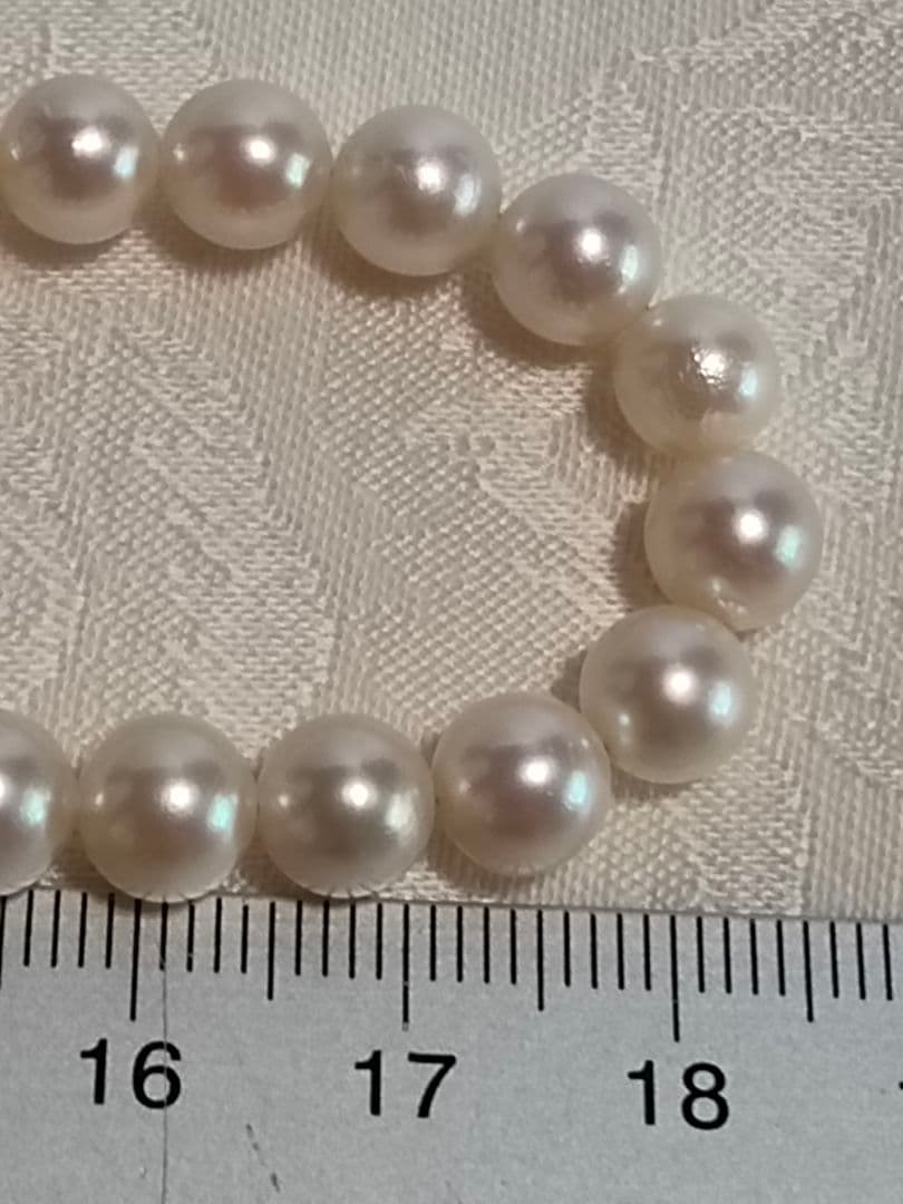 Akoya pearl necklace with 6.5-6.7mm white semi-round pearls and silver engraved bean-shaped clasp, 42.5cm length