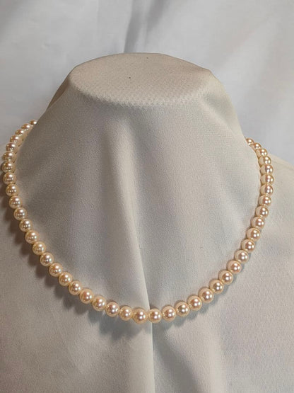 Akoya pearl necklace with 6.5-6.7mm white semi-round pearls and silver engraved bean-shaped clasp, 42.5cm length