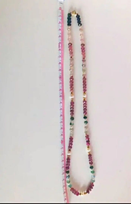 K18 gold necklace with 31 Akoya pearls and mixed cut tourmaline gemstones on display