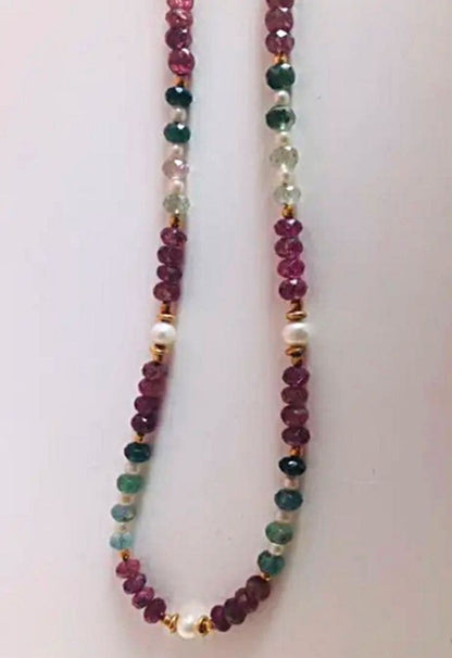 K18 gold necklace with 31 Akoya pearls and mixed cut tourmaline gemstones on display