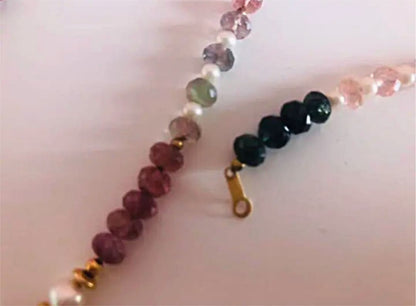 K18 gold necklace with 31 Akoya pearls and mixed cut tourmaline gemstones on display